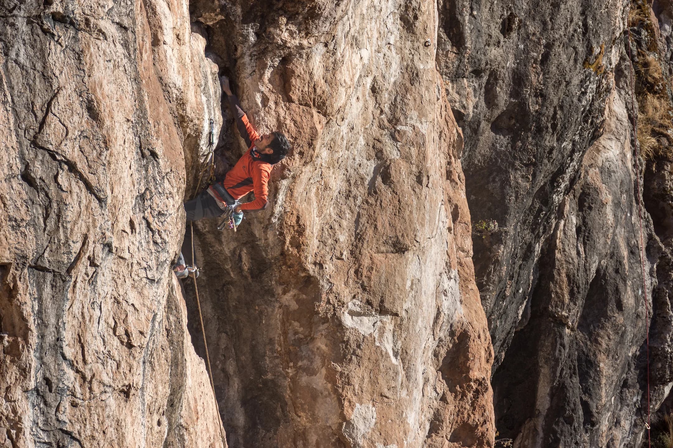 Lead climber on a limestone wall in Pitumarca, Peru.